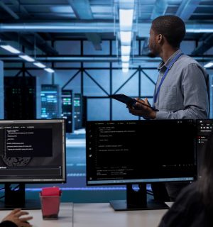 IT worker in server room monitoring server infrastructure